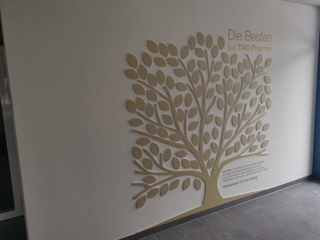 Goldener 3D-Baum an der Wand bei TAD Pharma.